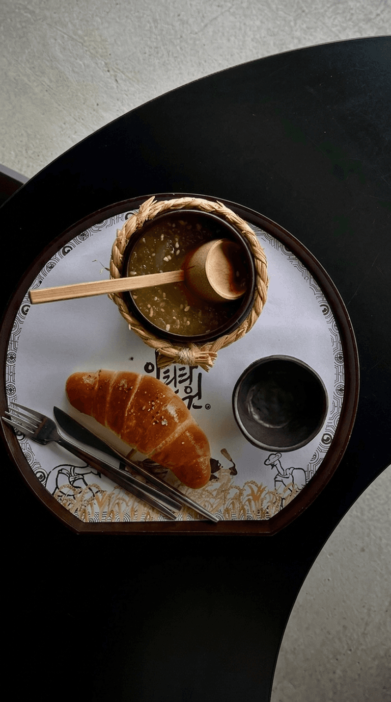 Croissant and green tea on a dark table